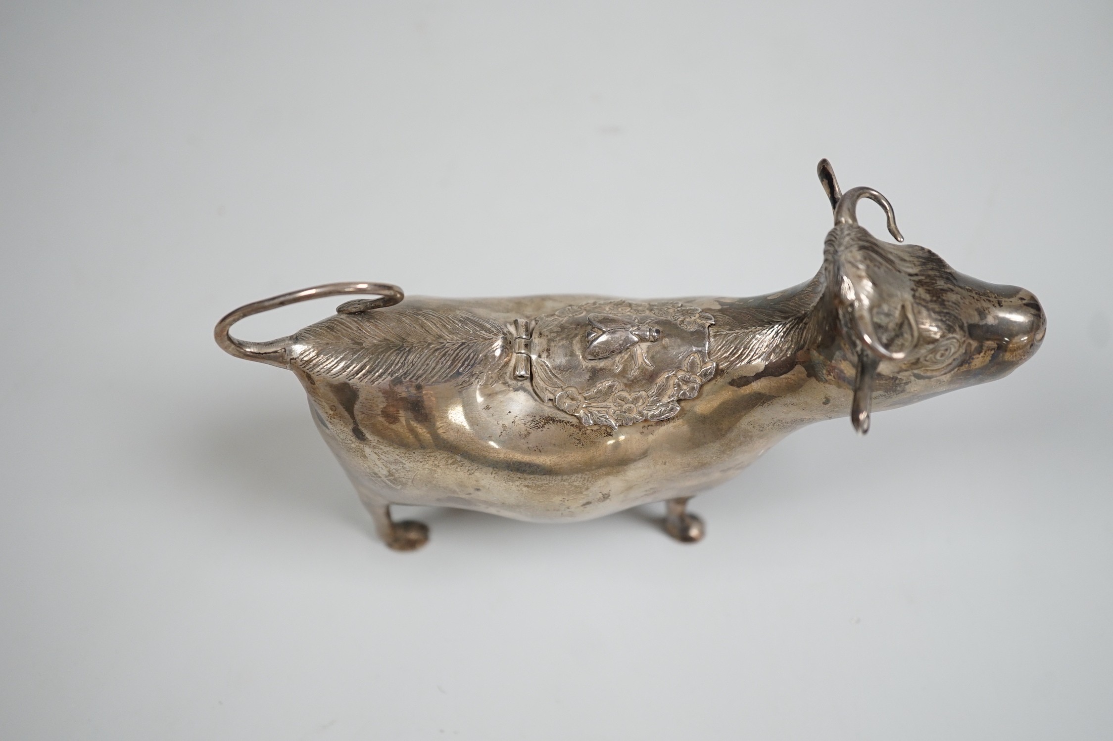An Elizabeth II silver cow creamer, William Comyns & Sons Ltd, London, 1965, length 15cm, 152 grams.